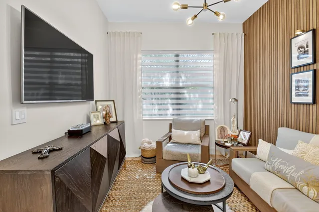 an aerial view of residential houses with outdoor space and trees all around