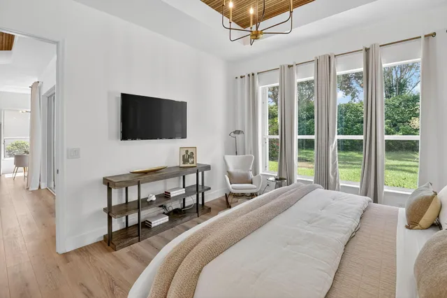 a view of a chairs and table in patio with a lake view