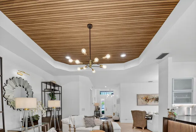 a kitchen with stainless steel appliances granite countertop a refrigerator a sink and white cabinets