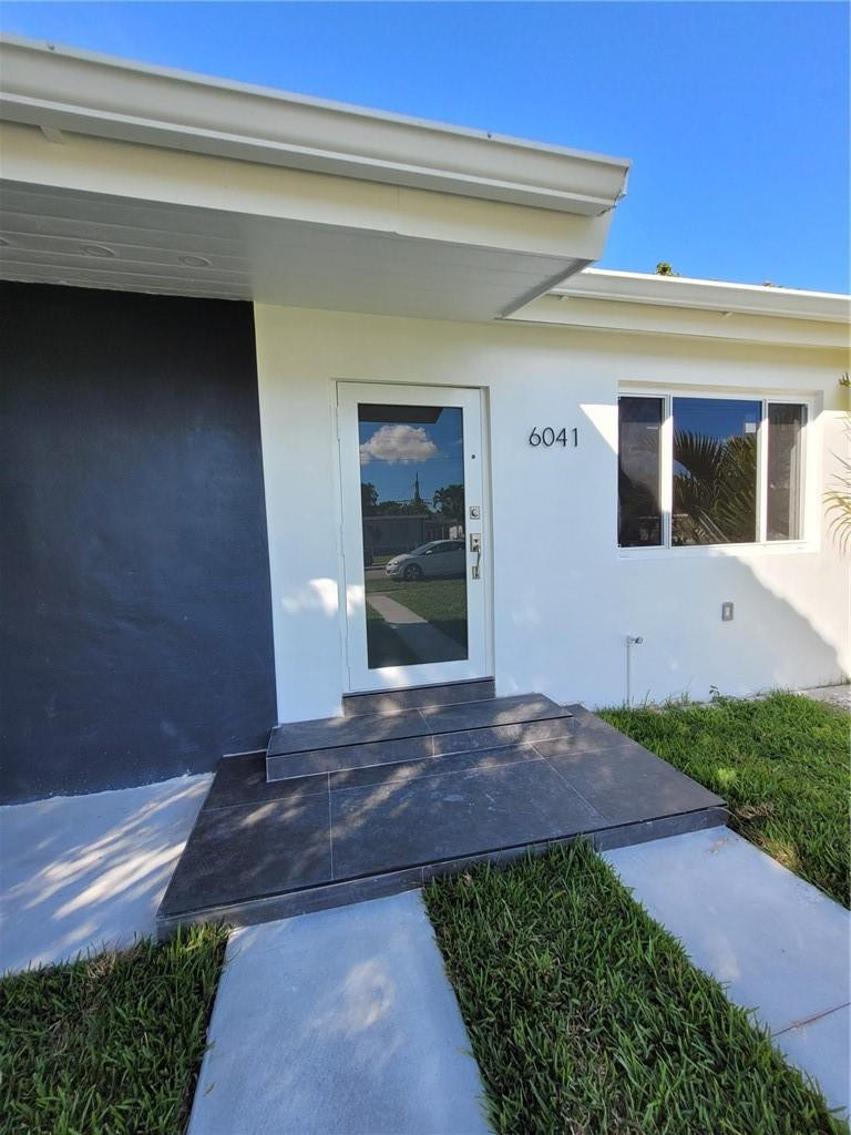 6041 Southwest 17th Street Miami, FL 33155 - Photo 2 of 26 a view of a house with a yard