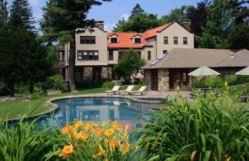 a front view of house with yard and swimming pool