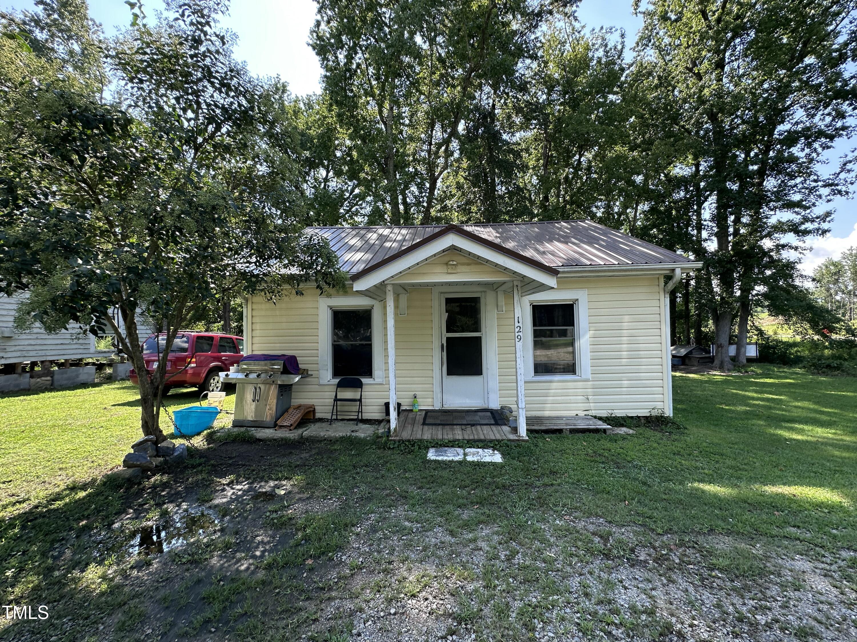 129 Spring Valley Road Henderson, NC 27536 - Photo 12 of 14 a view of a house with backyard