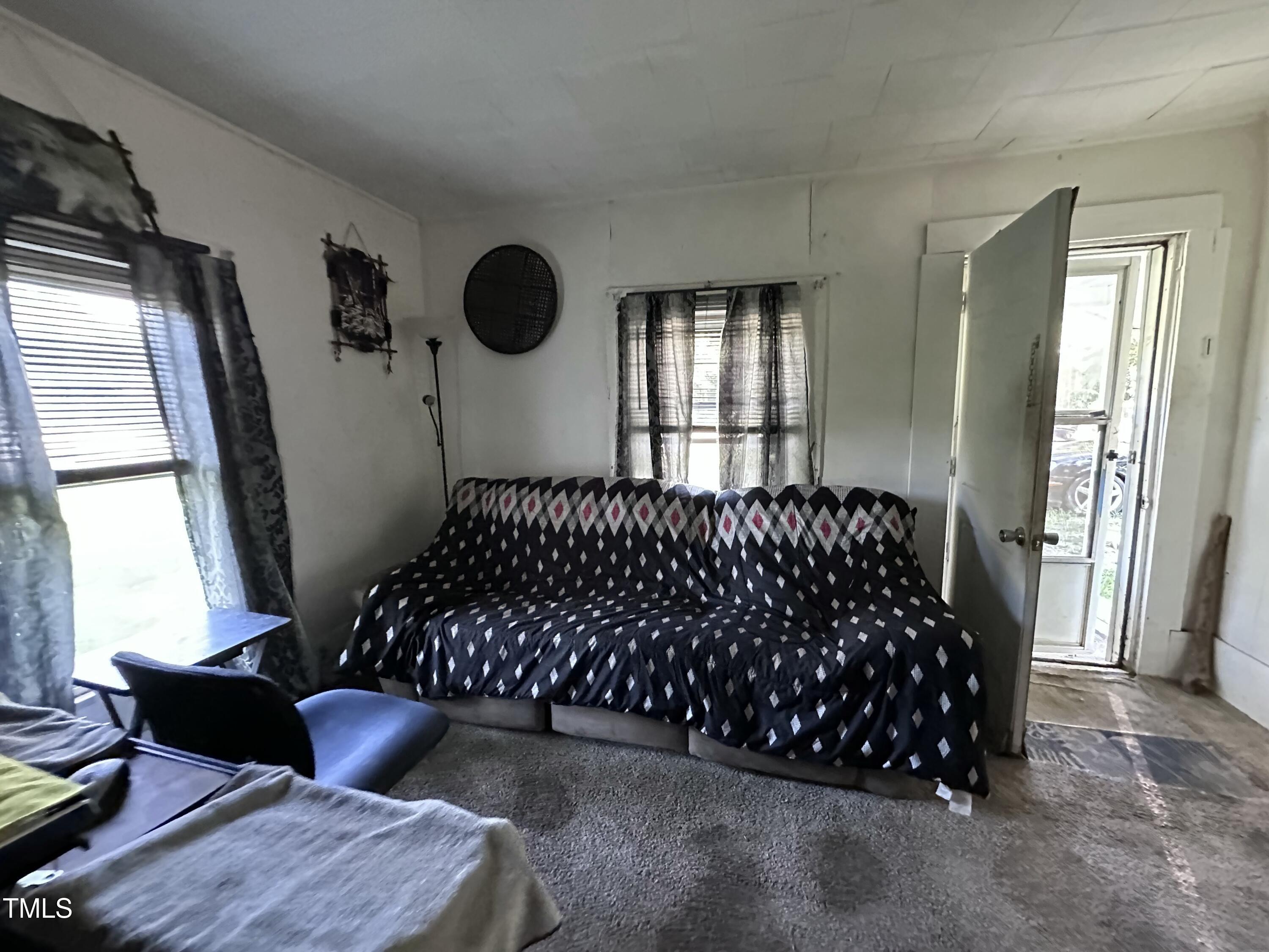 129 Spring Valley Road Henderson, NC 27536 - Photo 13 of 14 a bedroom with a bed and window