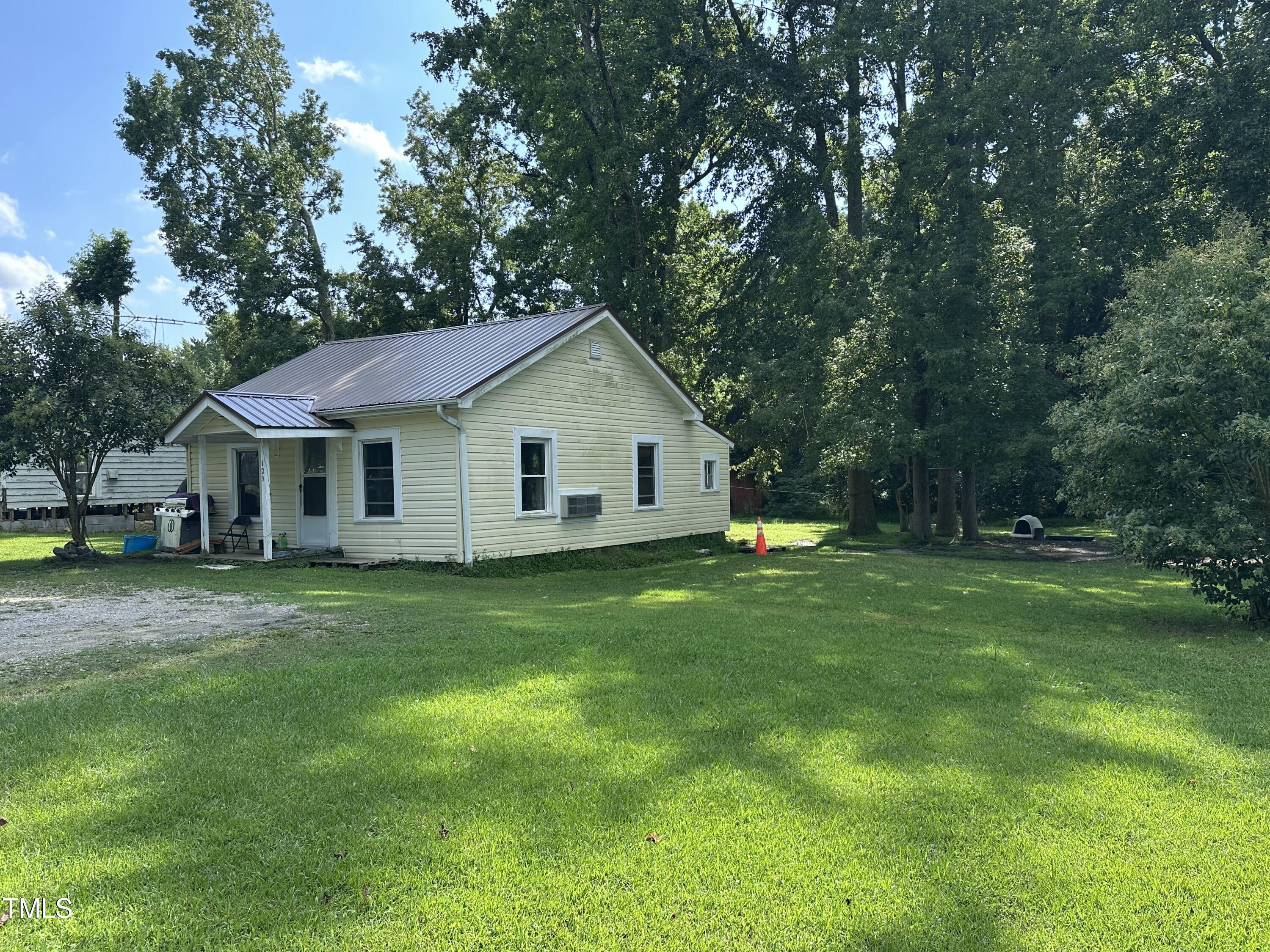 129 Spring Valley Road Henderson, NC 27536 - Photo 2 of 14 a view of a house with a backyard