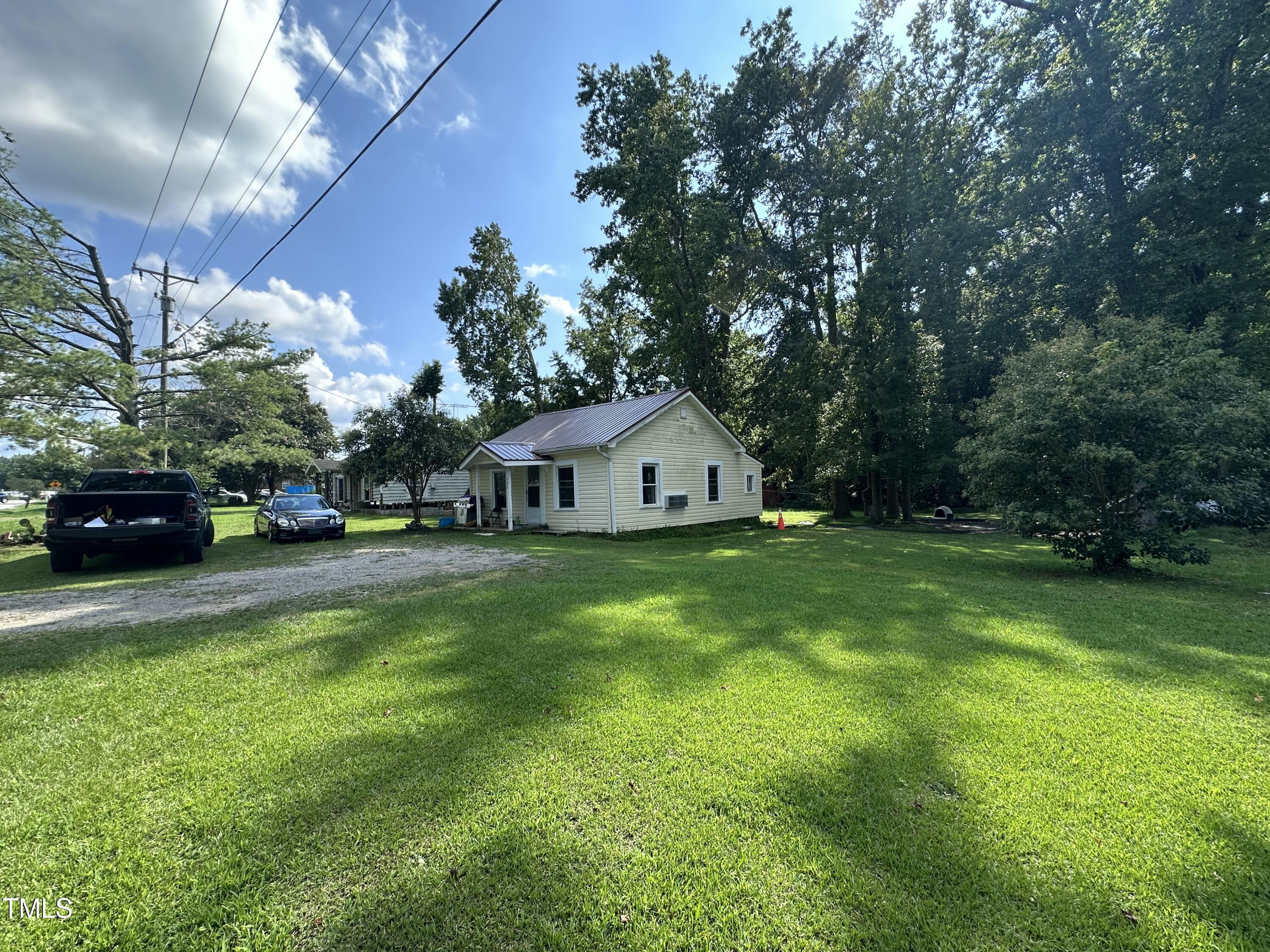 129 Spring Valley Road Henderson, NC 27536 - Photo 3 of 14 a front view of a house with garden