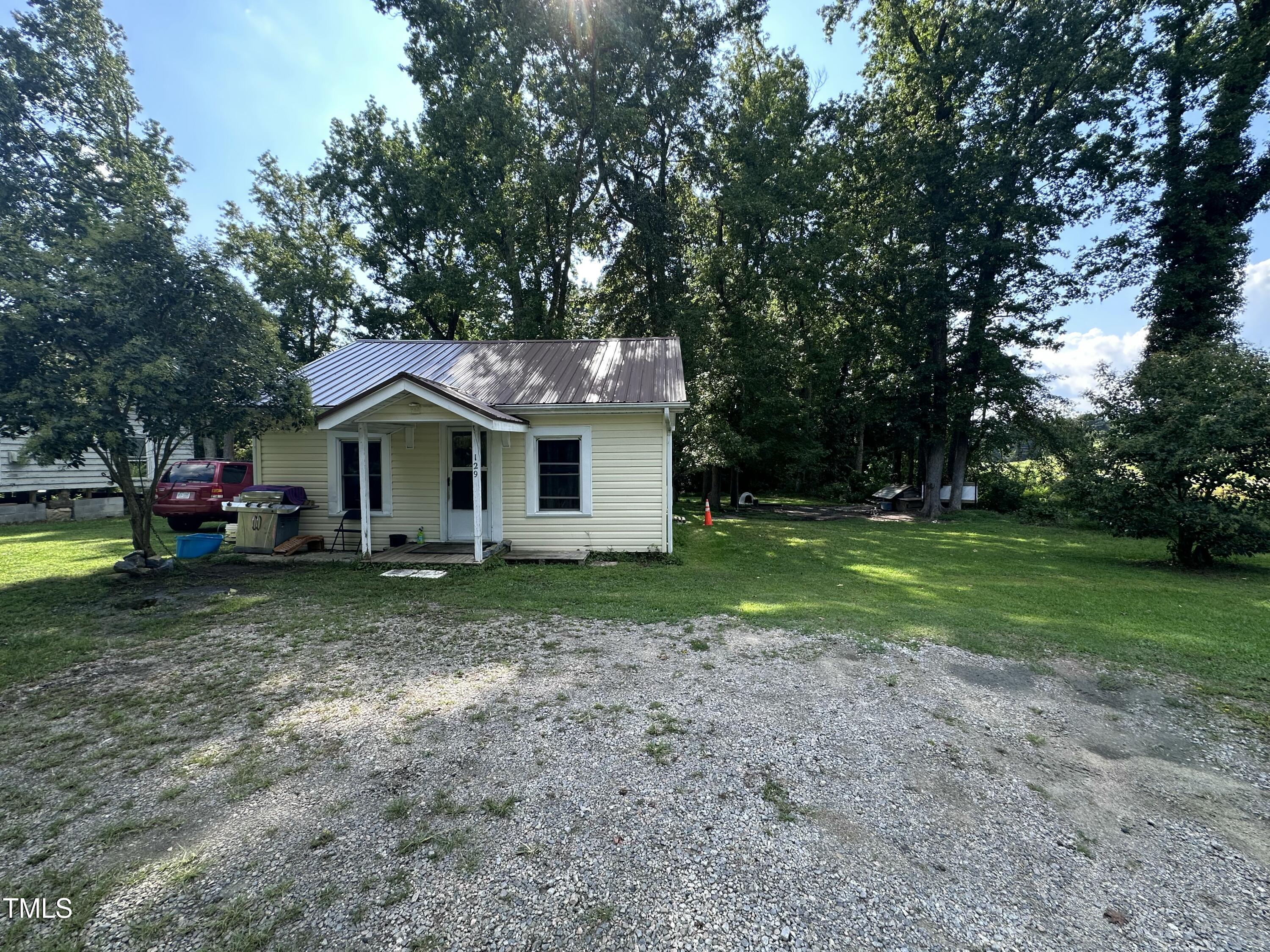 129 Spring Valley Road Henderson, NC 27536 - Photo 5 of 14 a view of a house with backyard