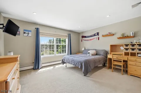 a spacious bedroom with a bed and a window
