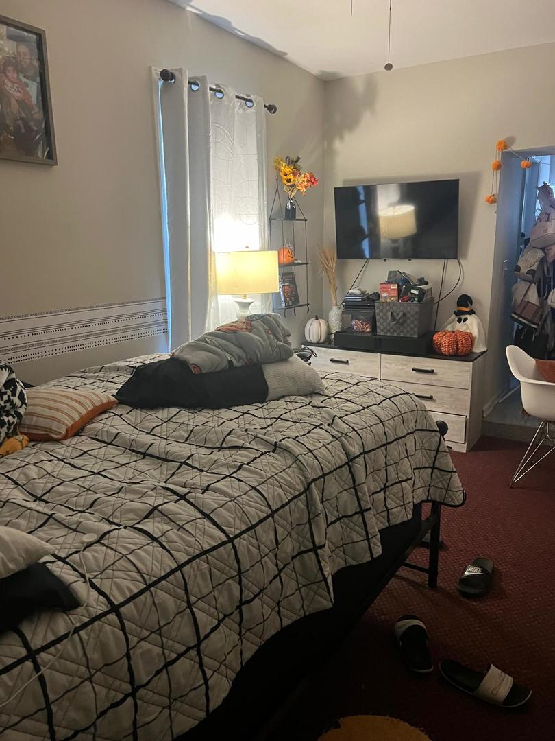 6155 South Whipple Street Chicago, IL 60629 - Photo 11 of 18 a bedroom with a bed and a window