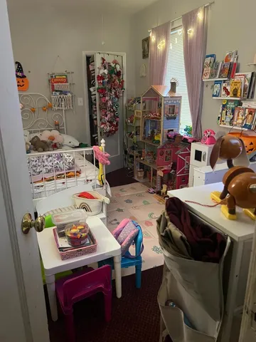 a room with furniture a rug toys and a chandelier