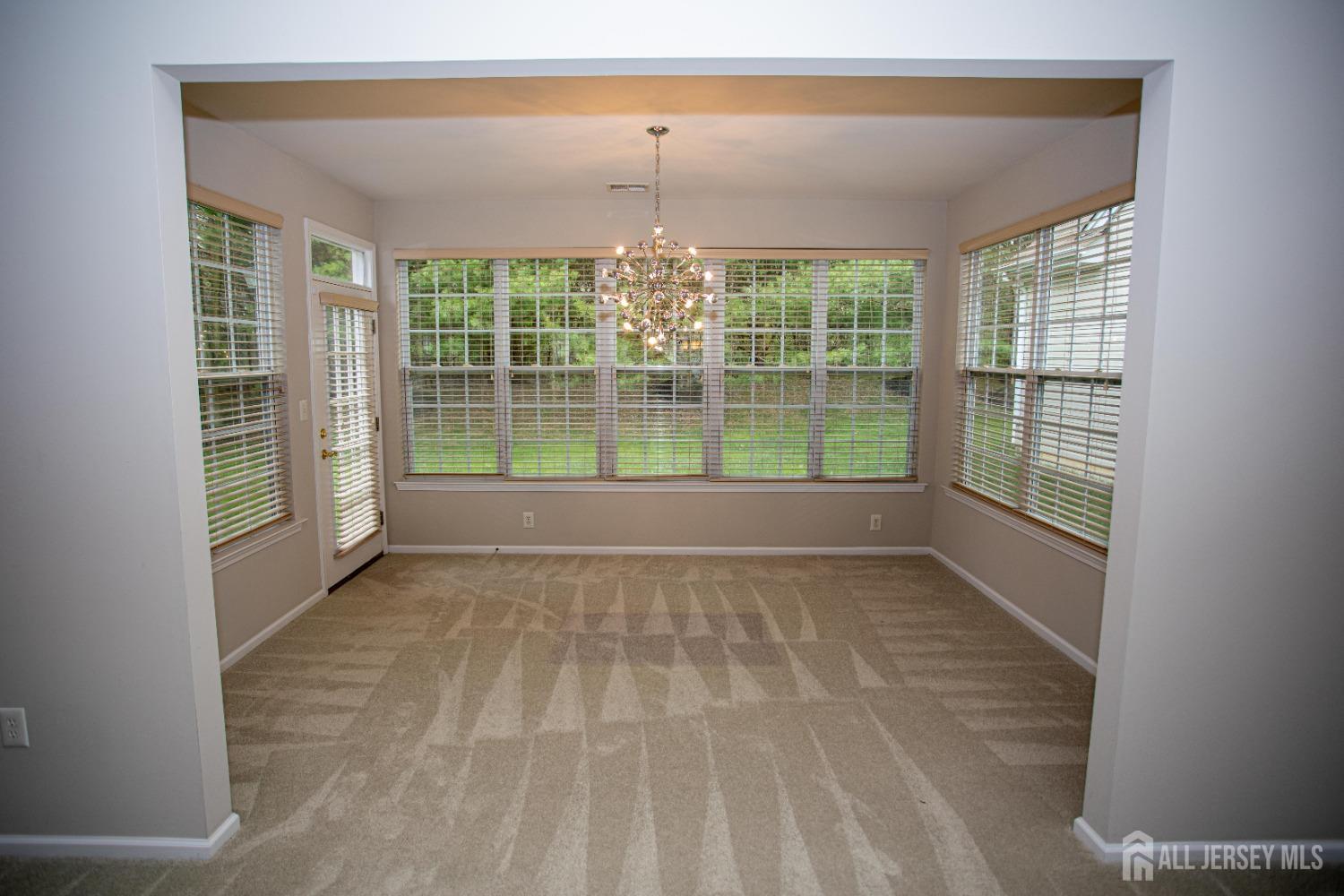 247 Spring Meadow Way Monroe Township, NJ 08831 - Photo 12 of 32 a view of empty room with wooden floor and fan