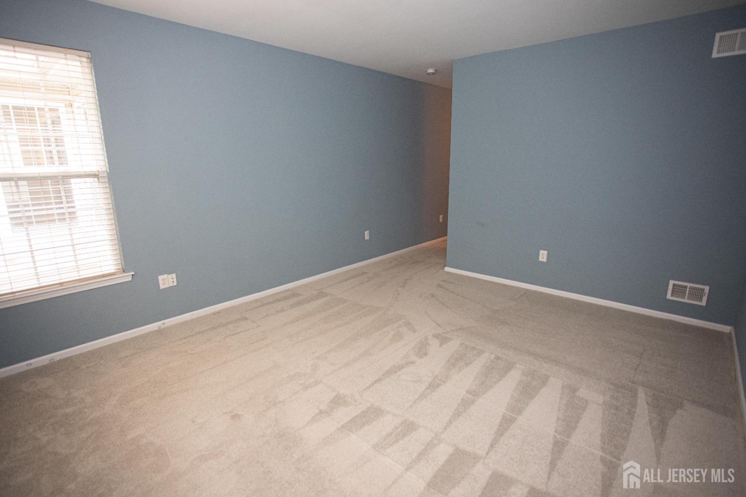 247 Spring Meadow Way Monroe Township, NJ 08831 - Photo 14 of 32 a view of an empty room with a window
