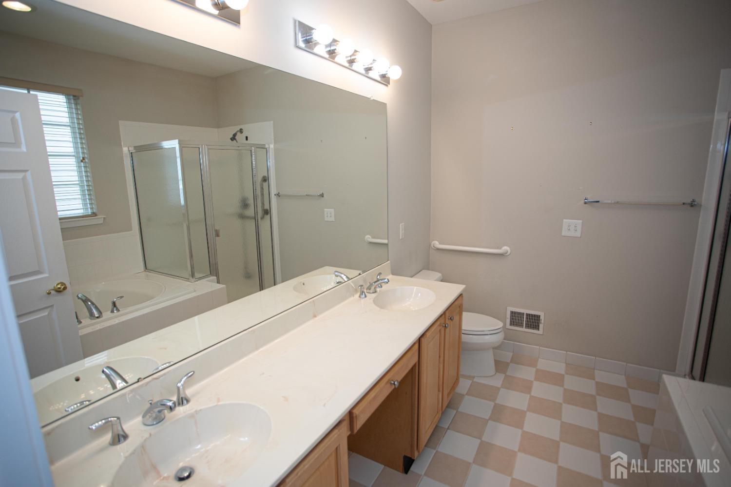 247 Spring Meadow Way Monroe Township, NJ 08831 - Photo 19 of 32 a bathroom with a sink a toilet and shower