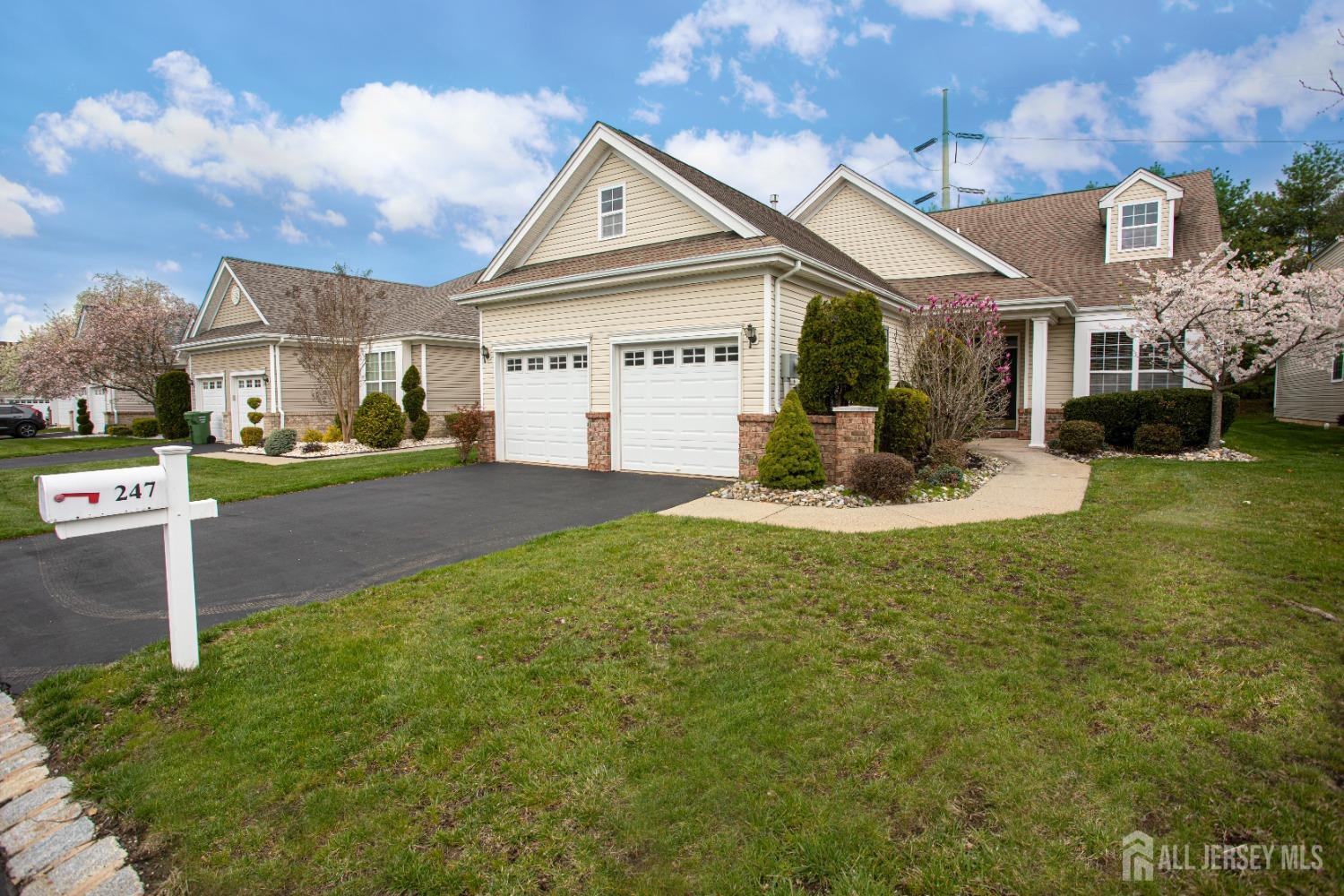 247 Spring Meadow Way Monroe Township, NJ 08831 - Photo 2 of 32 a view of a big house with a big yard and large tree