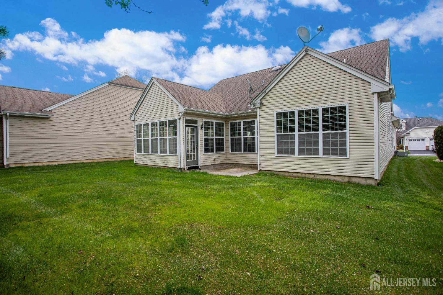 247 Spring Meadow Way Monroe Township, NJ 08831 - Photo 28 of 32 a view of a house with a yard