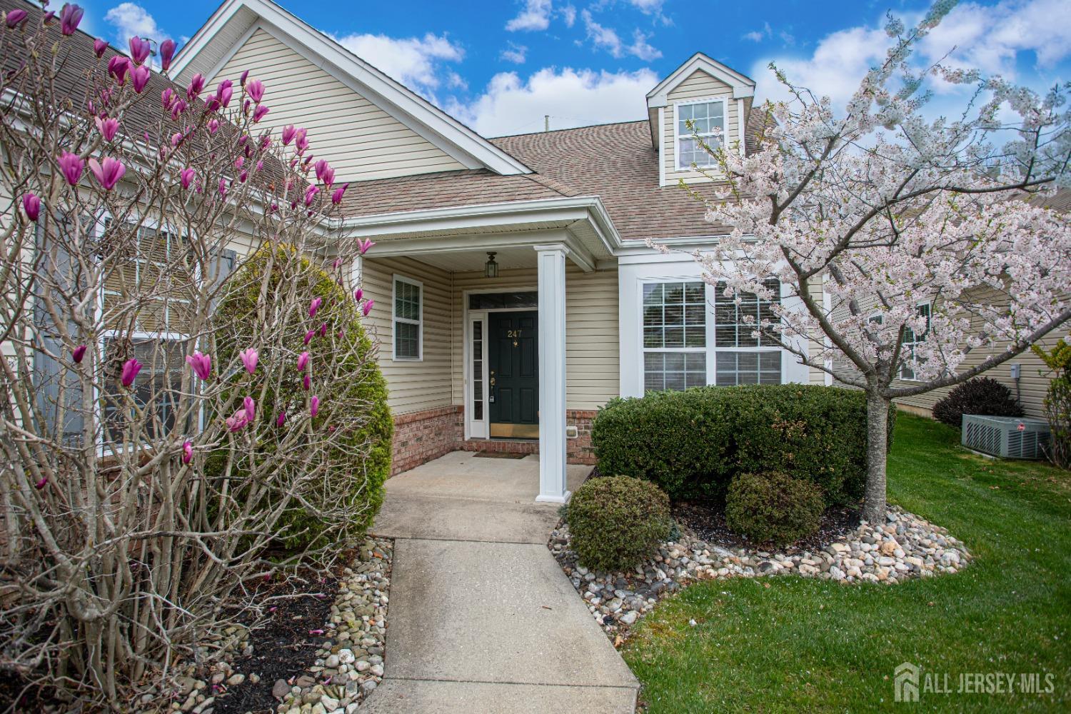 247 Spring Meadow Way Monroe Township, NJ 08831 - Photo 4 of 32 a front view of a house with a porch