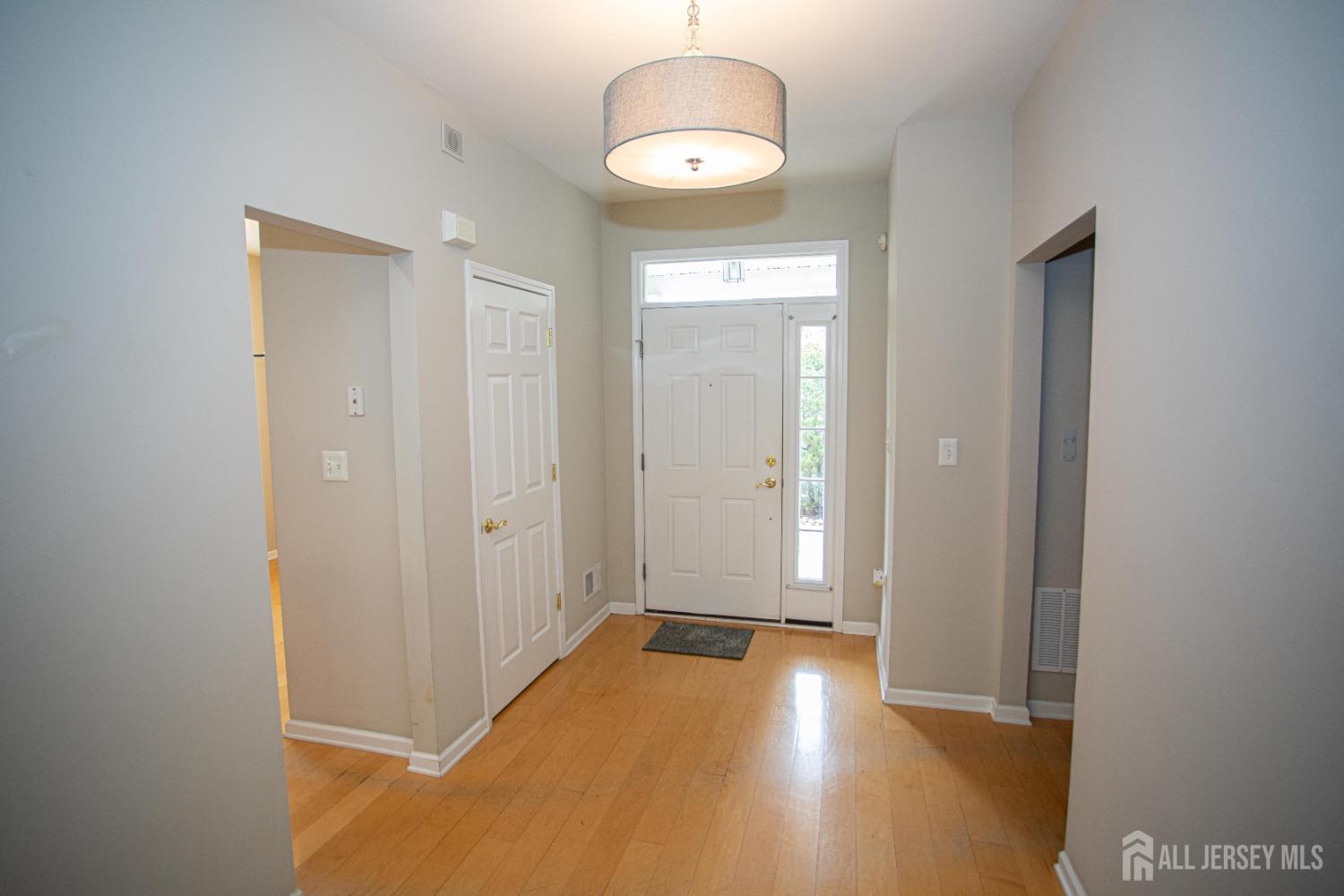 247 Spring Meadow Way Monroe Township, NJ 08831 - Photo 5 of 32 a view of empty room with wooden floor