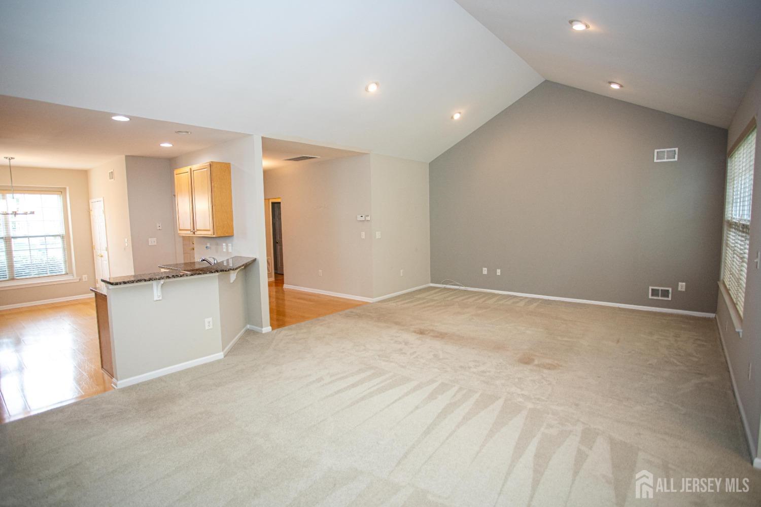247 Spring Meadow Way Monroe Township, NJ 08831 - Photo 10 of 32 a view of an empty room with window and wooden floor