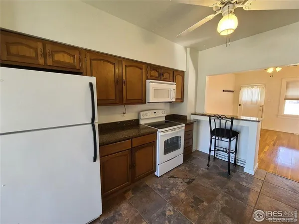 a white refrigerator freezer sitting in a kitchen