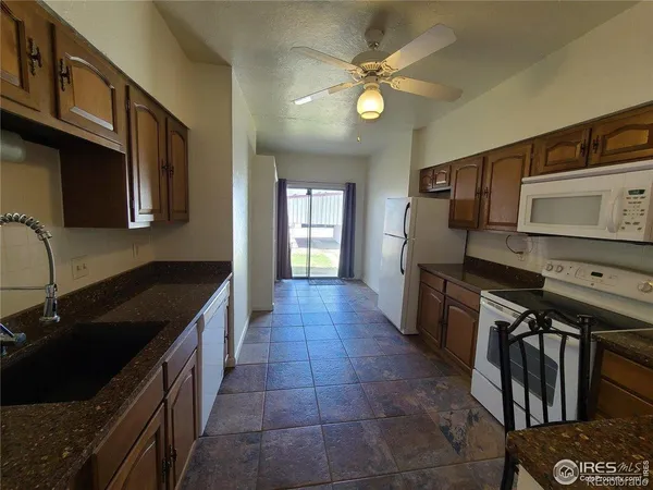 a kitchen with stainless steel appliances granite countertop a sink and a stove top oven