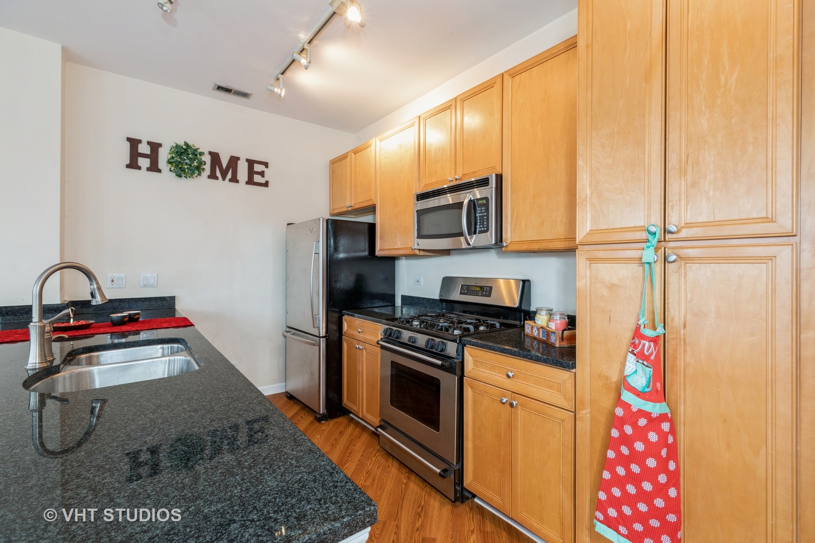 1500 South Halsted Street, Unit 3B Chicago, IL 60607 - Photo 12 of 33 a kitchen with stainless steel appliances granite countertop a stove a sink and a refrigerator