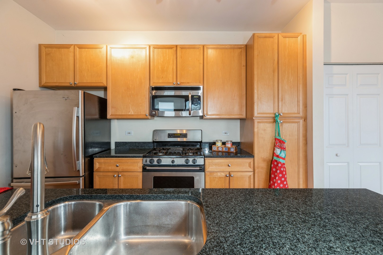 1500 South Halsted Street, Unit 3B Chicago, IL 60607 - Photo 14 of 33 a kitchen with stainless steel appliances granite countertop a stove a sink and a refrigerator