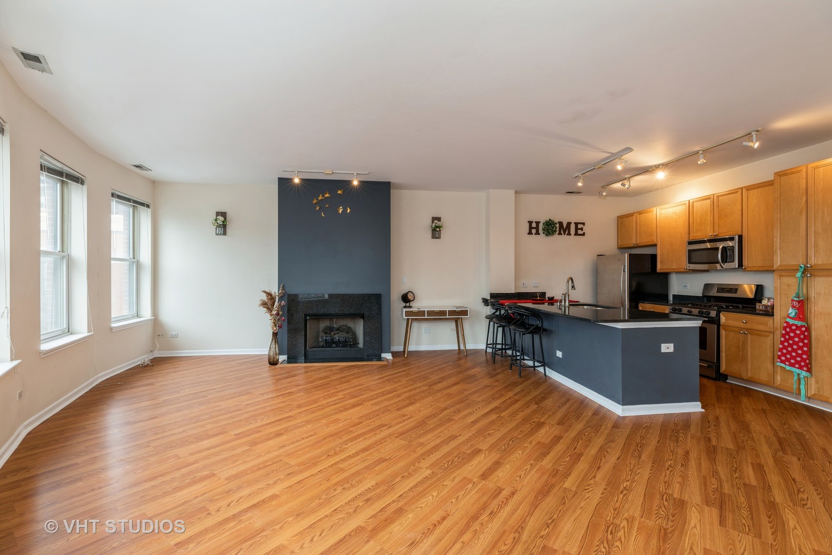 1500 South Halsted Street, Unit 3B Chicago, IL 60607 - Photo 8 of 33 a kitchen with stainless steel appliances kitchen island granite countertop a refrigerator a stove top oven and a sink with granite countertops