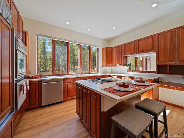 a kitchen with a stove a sink and a refrigerator