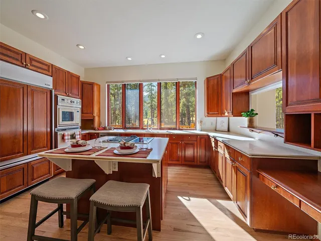 a kitchen with stainless steel appliances granite countertop a sink and a stove