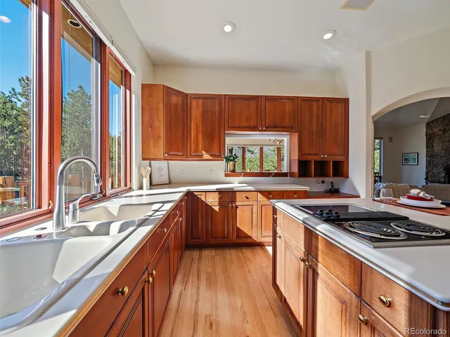 a kitchen with stainless steel appliances granite countertop a sink stove and cabinets