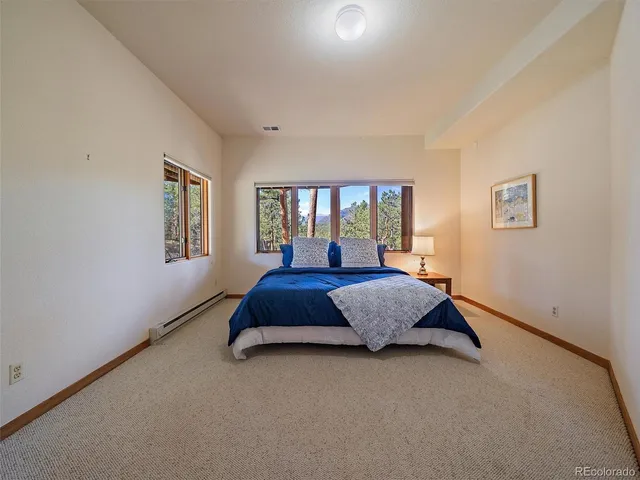 a spacious bathroom with a shower sink and mirror
