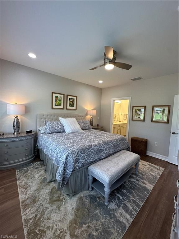 9113 Michael Circle, Unit 7710 Naples, FL 34113 - Photo 13 of 34 a spacious bedroom with a bed a chandelier and a window