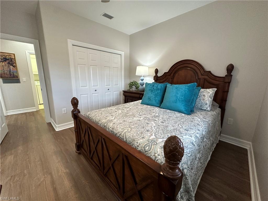 9113 Michael Circle, Unit 7710 Naples, FL 34113 - Photo 18 of 34 a bed sitting in a bedroom next to a window