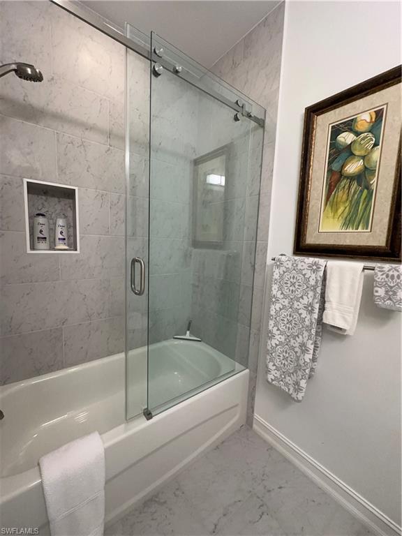 9113 Michael Circle, Unit 7710 Naples, FL 34113 - Photo 20 of 34 a bathroom with a bathtub and a shower