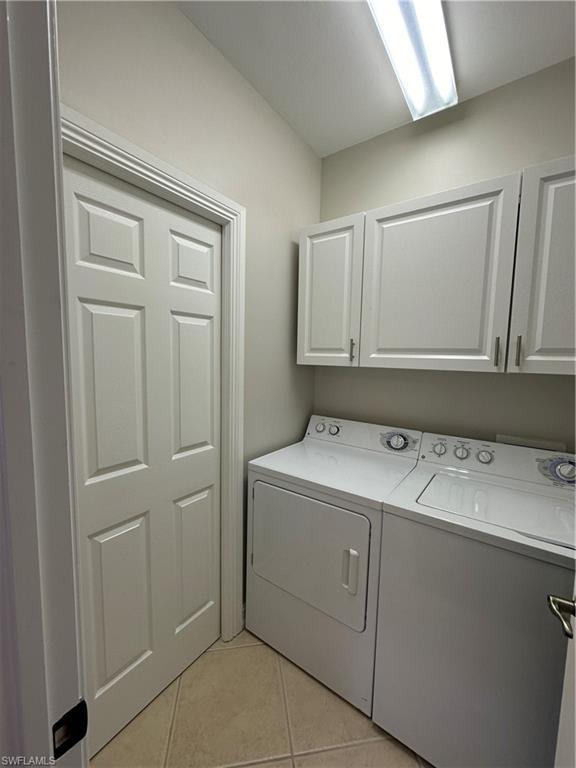 9113 Michael Circle, Unit 7710 Naples, FL 34113 - Photo 21 of 34 a utility room with cabinets washer and dryer