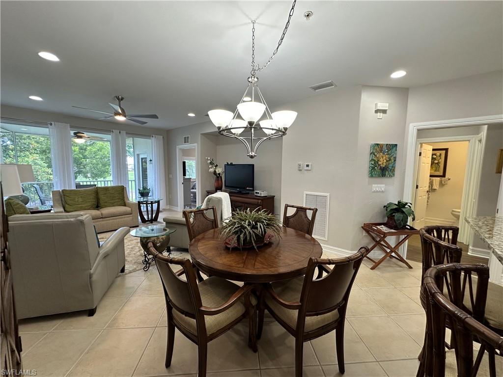 9113 Michael Circle, Unit 7710 Naples, FL 34113 - Photo 4 of 34 a view of a dining room with furniture and chandelier