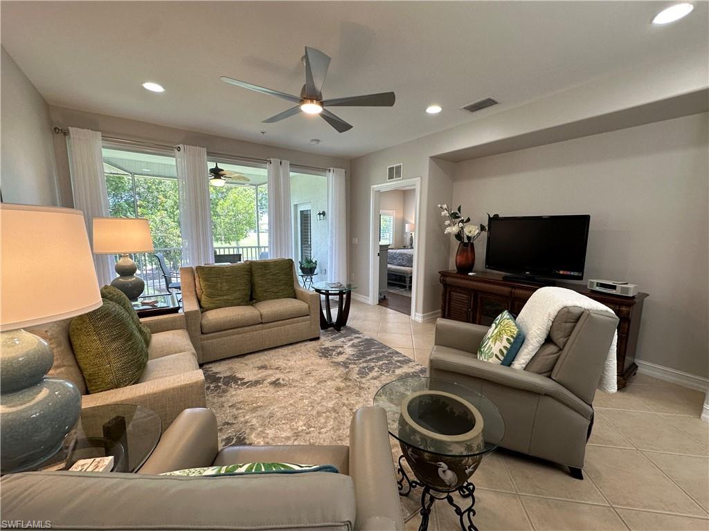 9113 Michael Circle, Unit 7710 Naples, FL 34113 - Photo 8 of 34 a living room with furniture and a flat screen tv