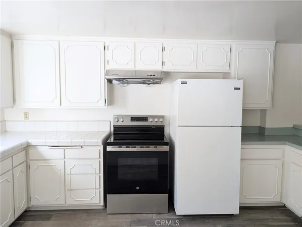 a white refrigerator freezer sitting inside of a kitchen