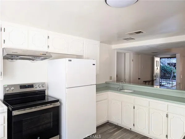 a kitchen with a refrigerator and a sink