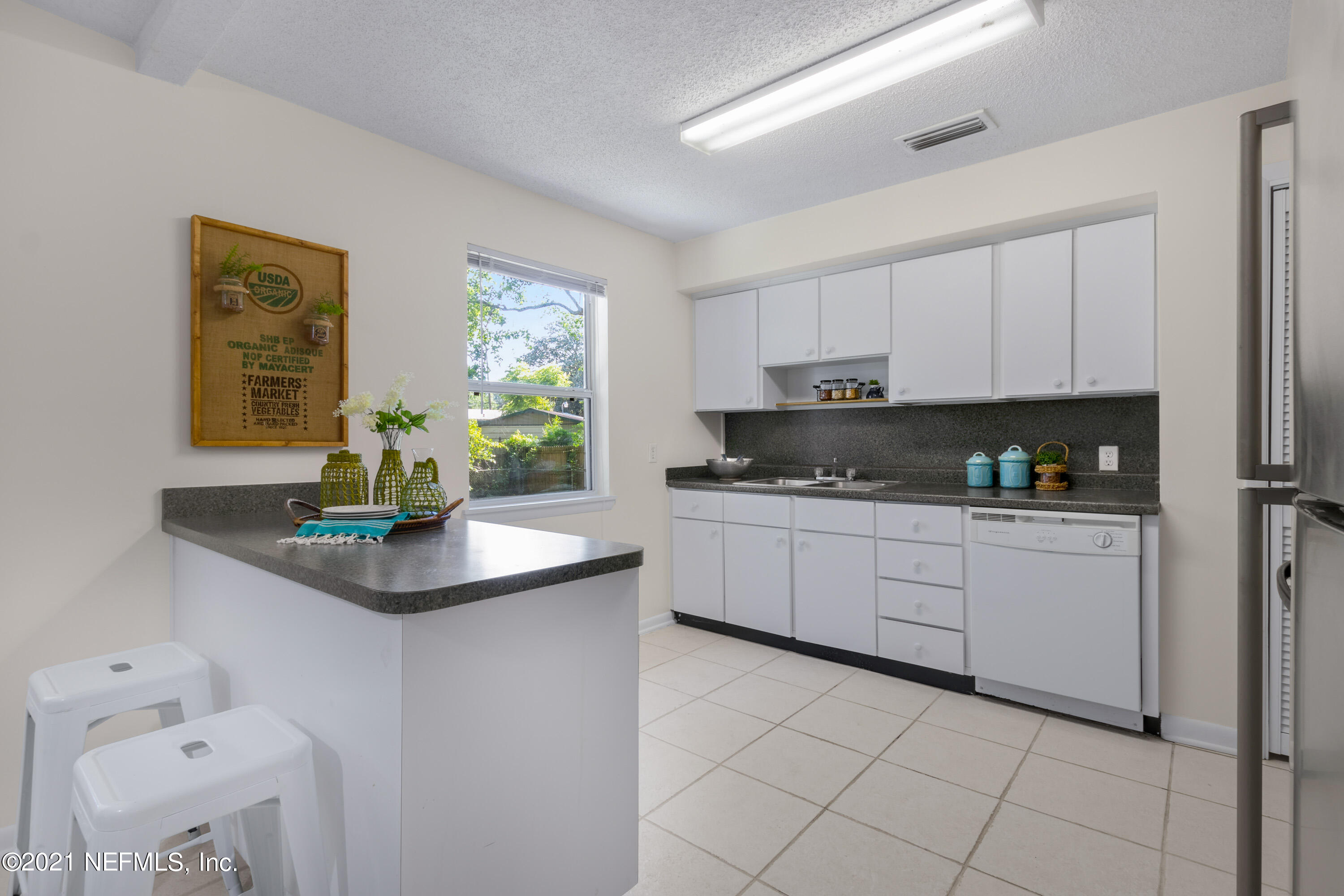 6554 Aires Road Jacksonville, FL 32244 - Photo 11 of 29 a kitchen with stainless steel appliances granite countertop a sink a stove and white cabinets