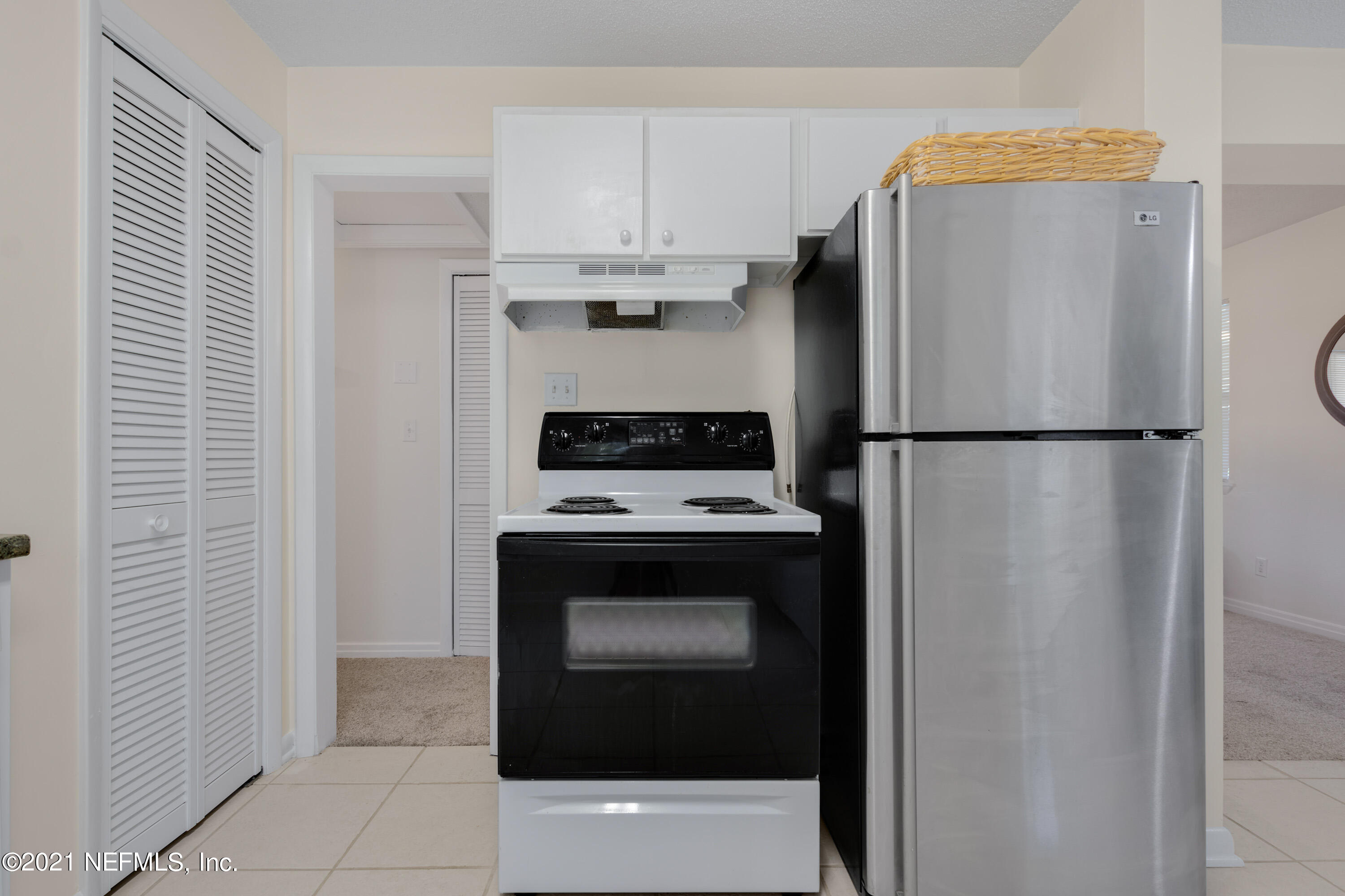 6554 Aires Road Jacksonville, FL 32244 - Photo 13 of 29 a kitchen with a refrigerator and a stove