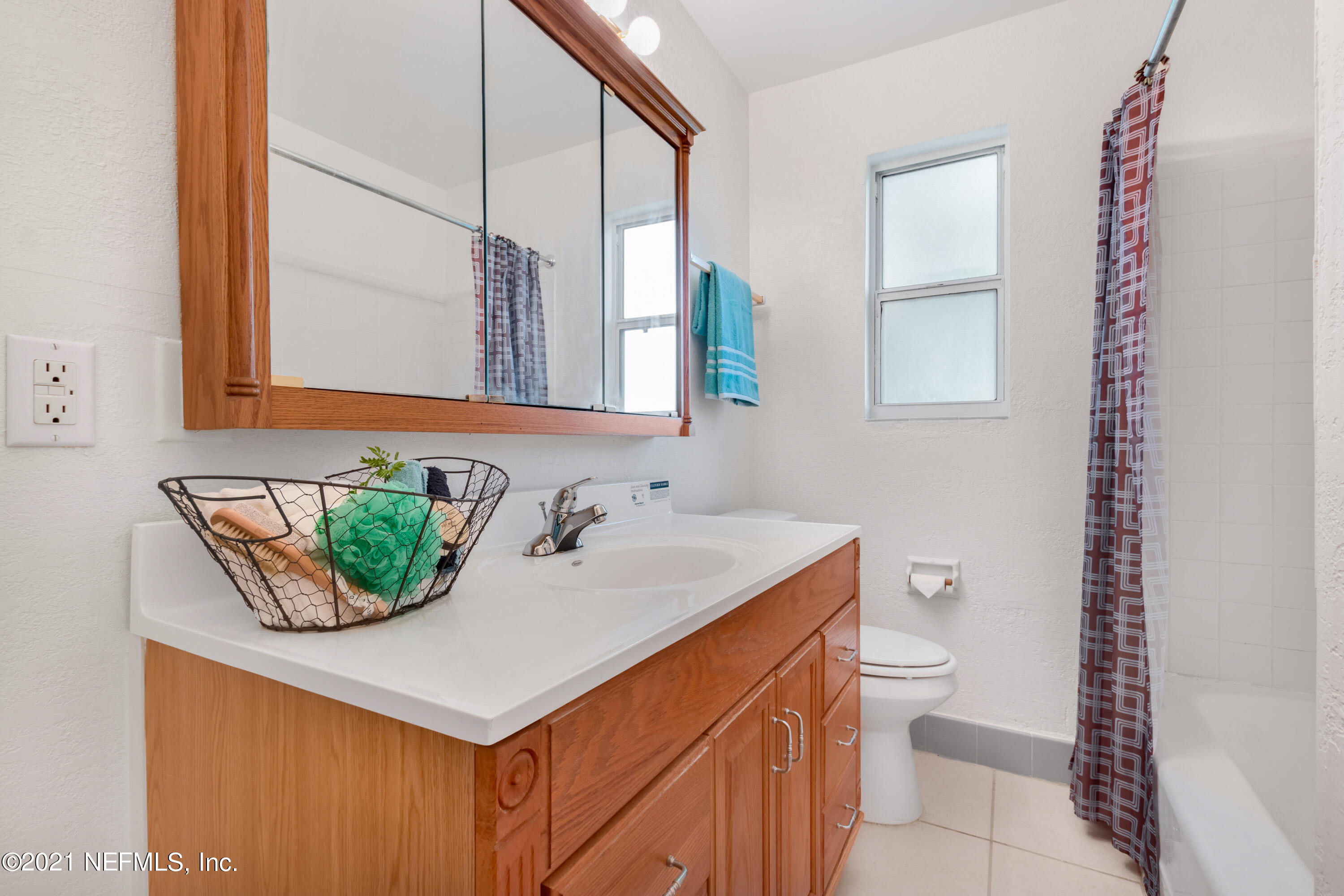 6554 Aires Road Jacksonville, FL 32244 - Photo 16 of 29 a bathroom with a sink toilet and mirror
