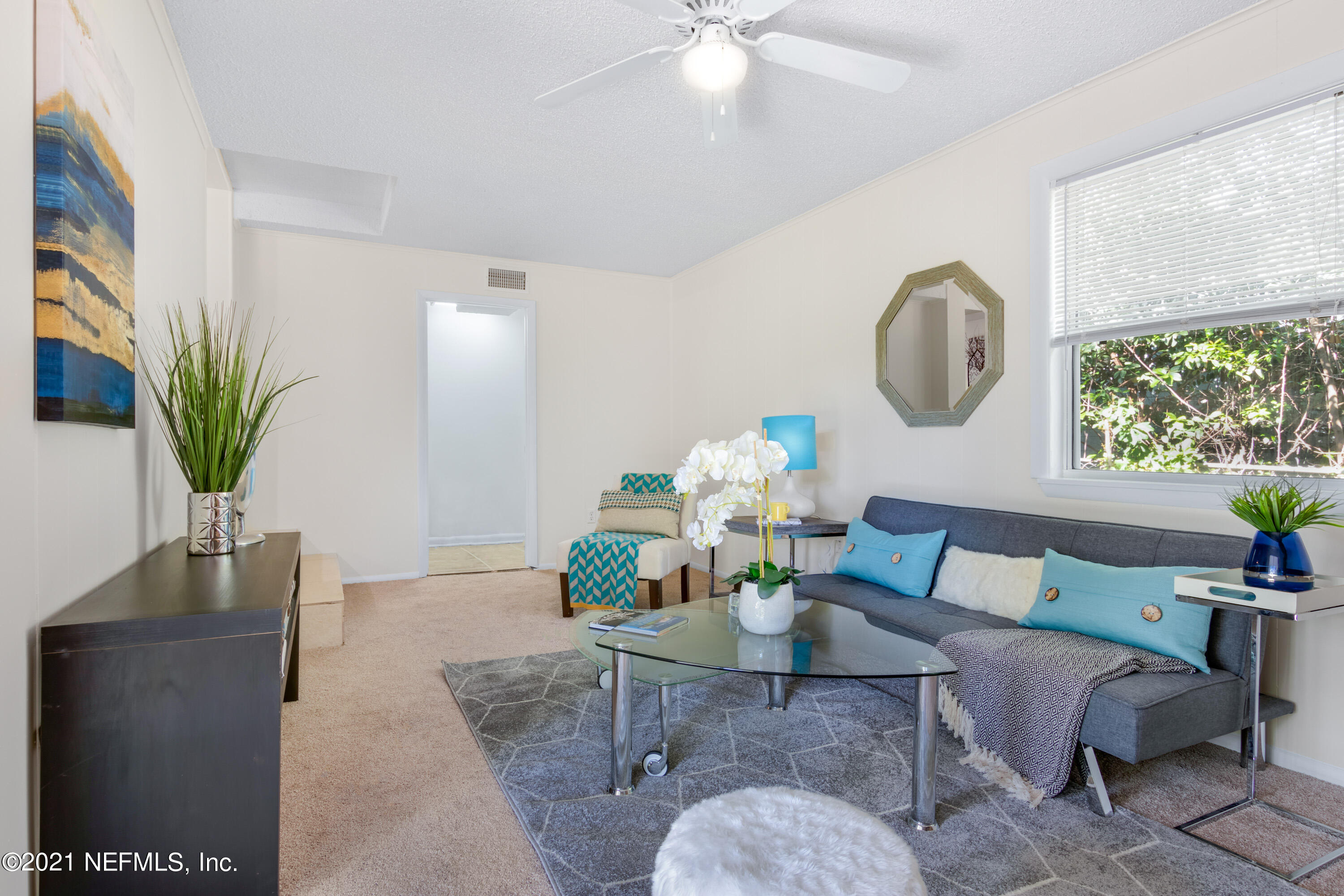6554 Aires Road Jacksonville, FL 32244 - Photo 5 of 29 a living room with furniture a dining table and a large window