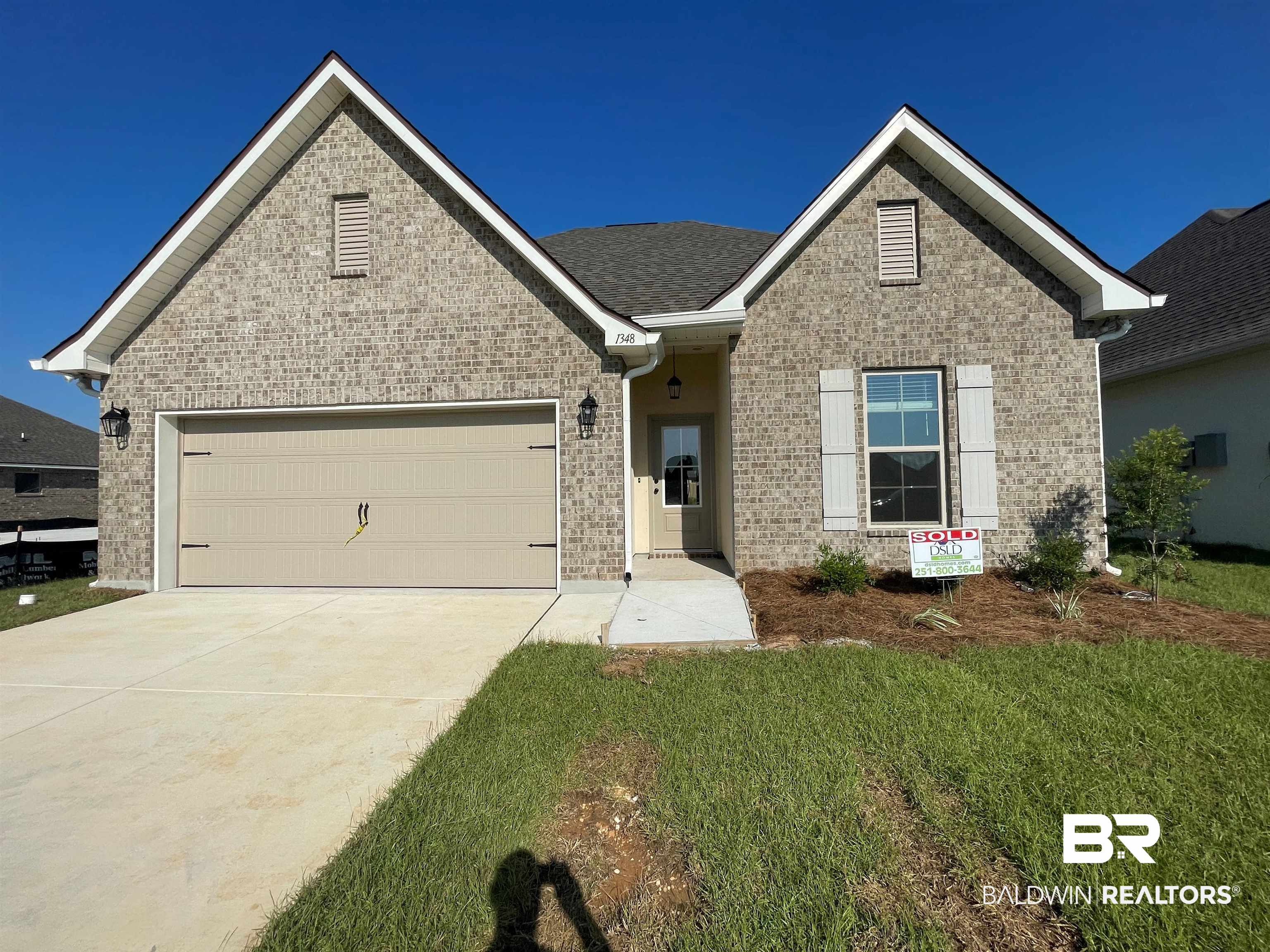 1348 Aldon Street Foley, AL 36535 - Photo 1 of 3 View of front of house featuring brick siding, driveway, and a garage