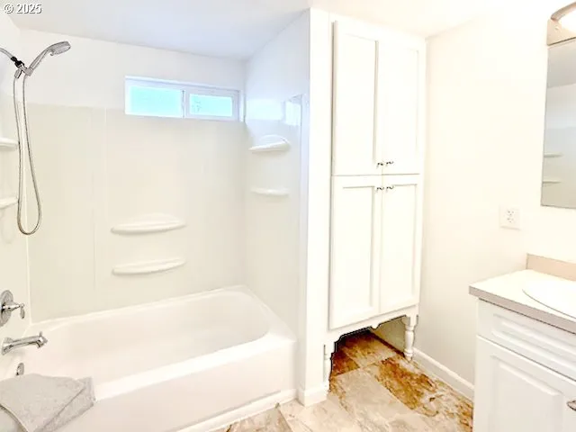 a bathroom with a bathtub and a shower