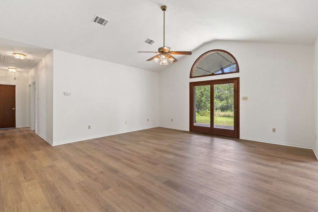 244 Woodway Elgin, TX 78621 - Photo 8 of 40 a view of empty room with wooden floor and fan