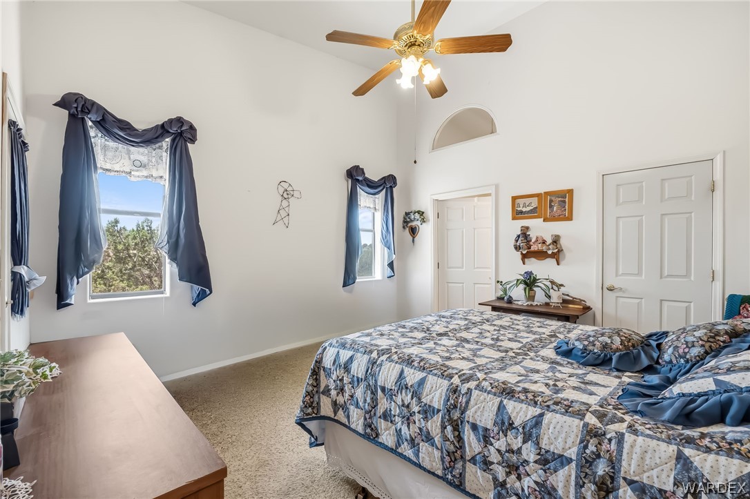 2401 North Stephan Road Kingman, AZ 86401 - Photo 42 of 92 a bedroom with a bed and a chandelier