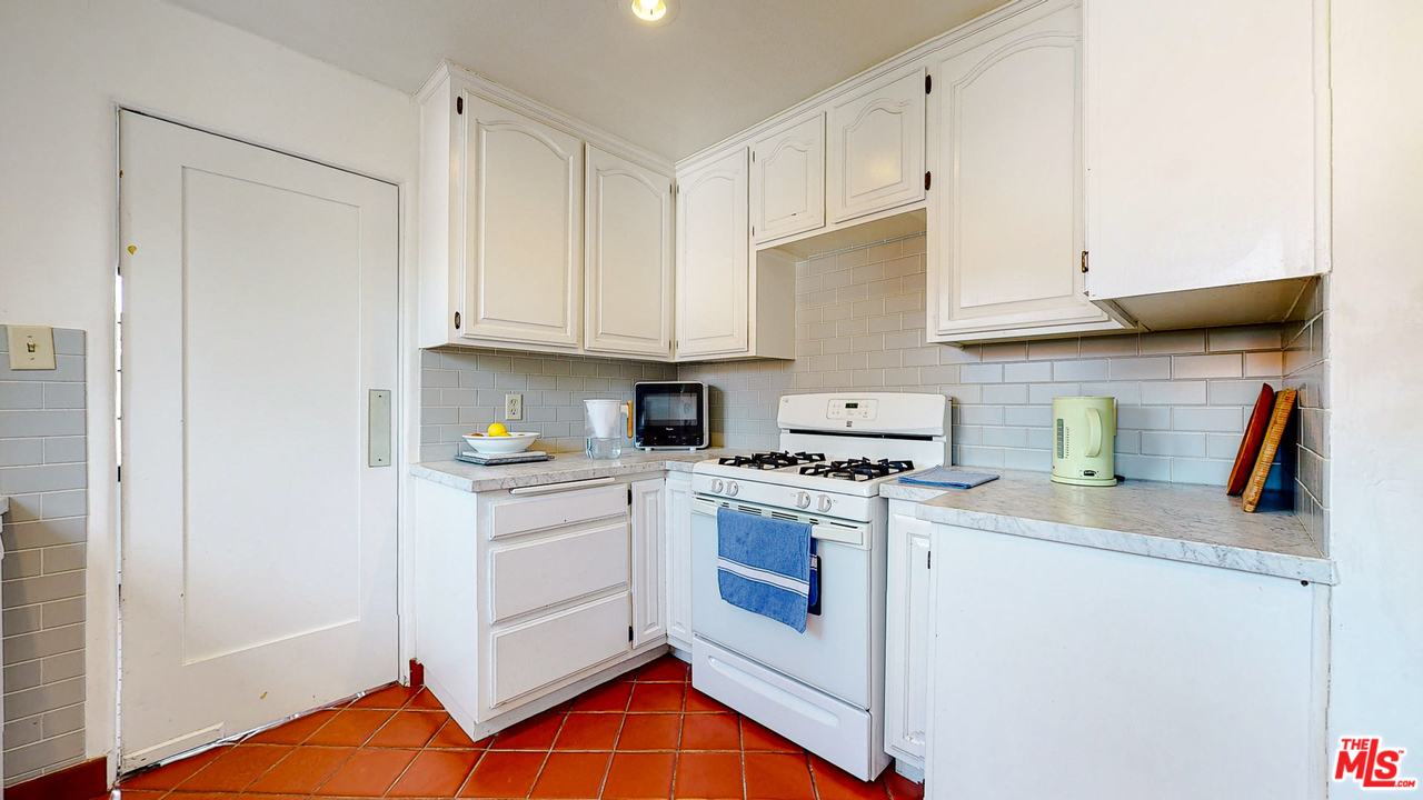 6854 Iris Circle Los Angeles, CA 90068 - Photo 12 of 35 a kitchen with stainless steel appliances granite countertop a stove a sink and a refrigerator