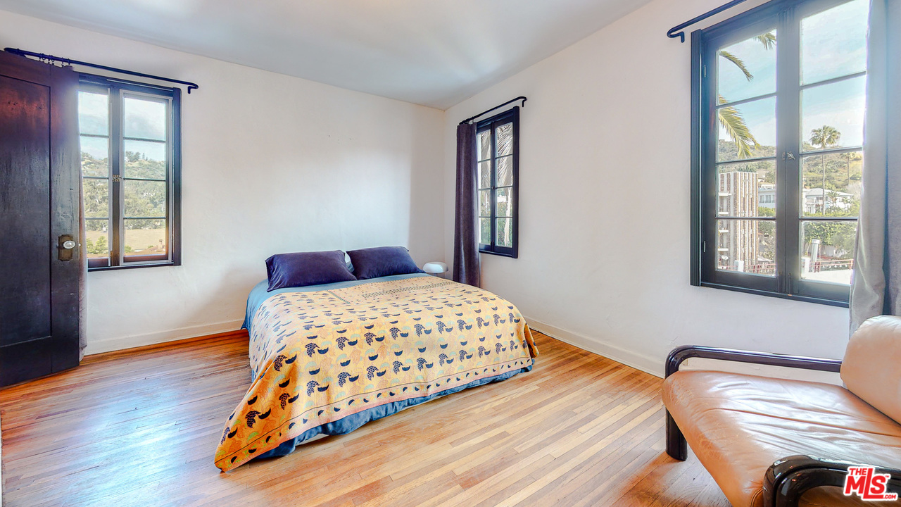 6854 Iris Circle Los Angeles, CA 90068 - Photo 16 of 35 a bedroom with a bed and wooden floor