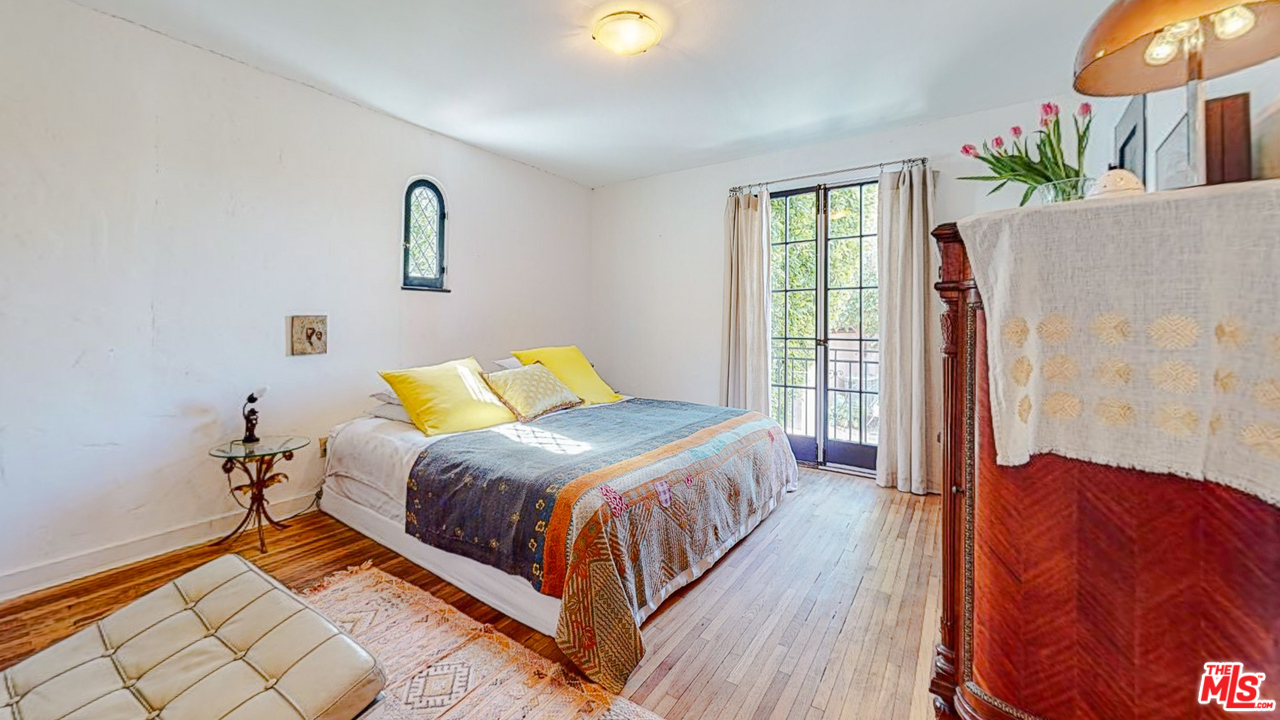 6854 Iris Circle Los Angeles, CA 90068 - Photo 18 of 35 a bedroom with a bed lamp and a potted plant
