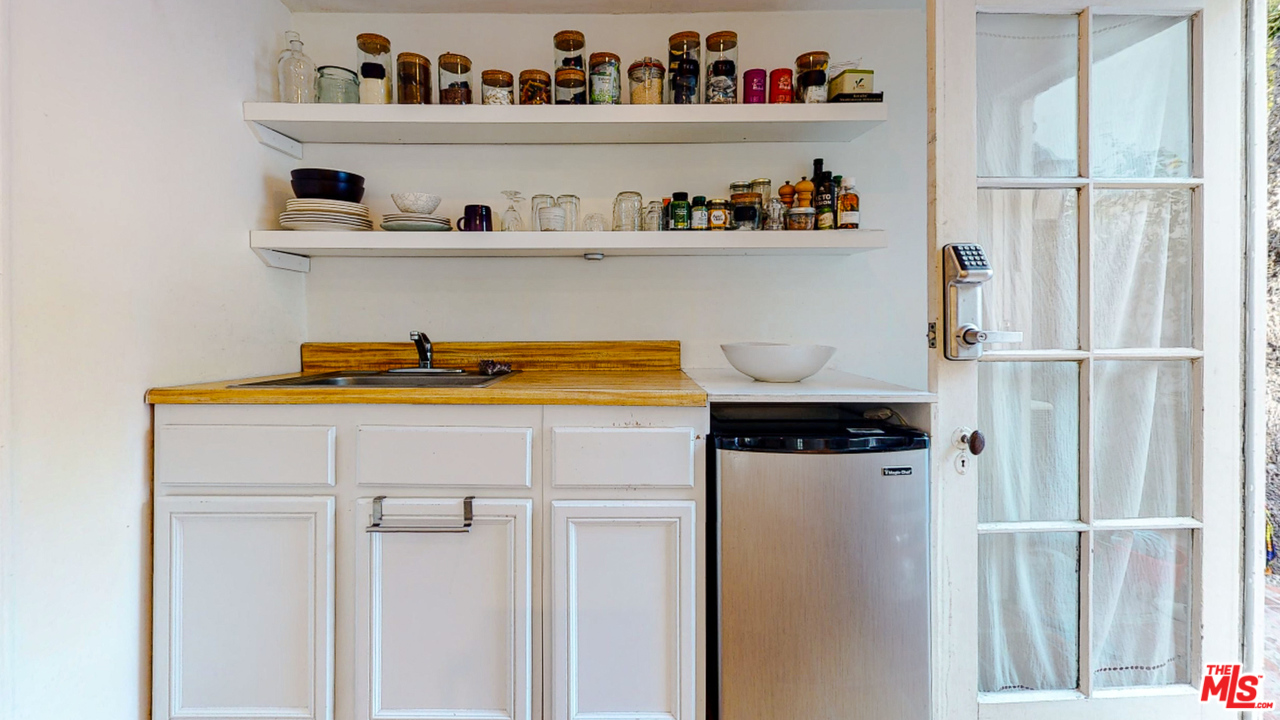 6854 Iris Circle Los Angeles, CA 90068 - Photo 27 of 35 a kitchen with a refrigerator and a shelf